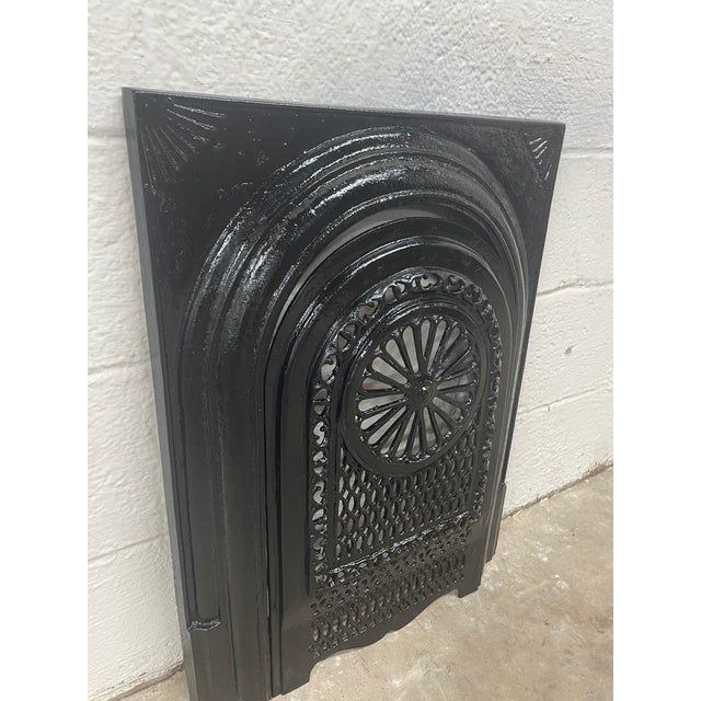 A remarkable piece of Southern architectural history, this late 19th-century cast iron fireplace surround and matching...