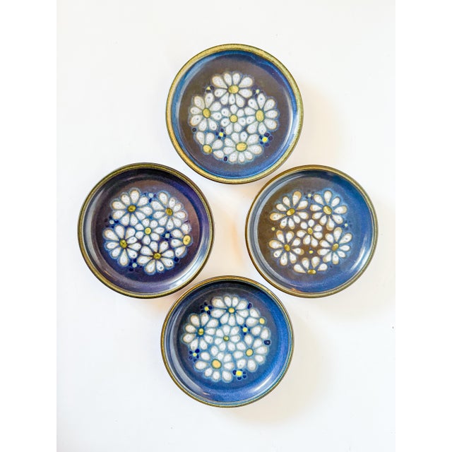 Charming set of four vintage 1970s Denby Kismet Blue daisy bread and butter plates. The background of the stoneware is a...