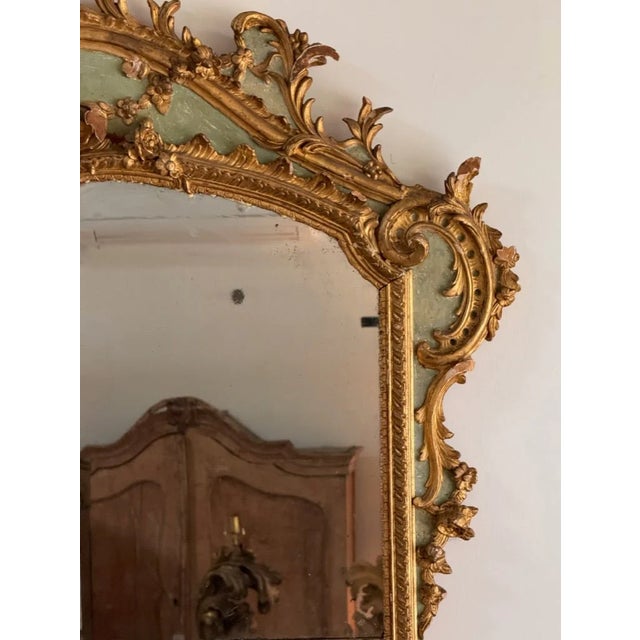 A large French green-painted and giltwood mirror having two panels, likely an overmantel mirror, second half 19th century....