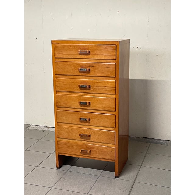 A tall chest of drawers/"seventiera" (high chest of drawers) from the 1950s, made in Italy, with clean, functional lines....