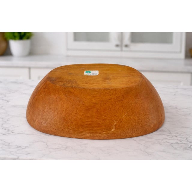 This beautifully sculpted vintage bowl is hand turned from solid teak, showcasing rich golden-brown tones and striking...