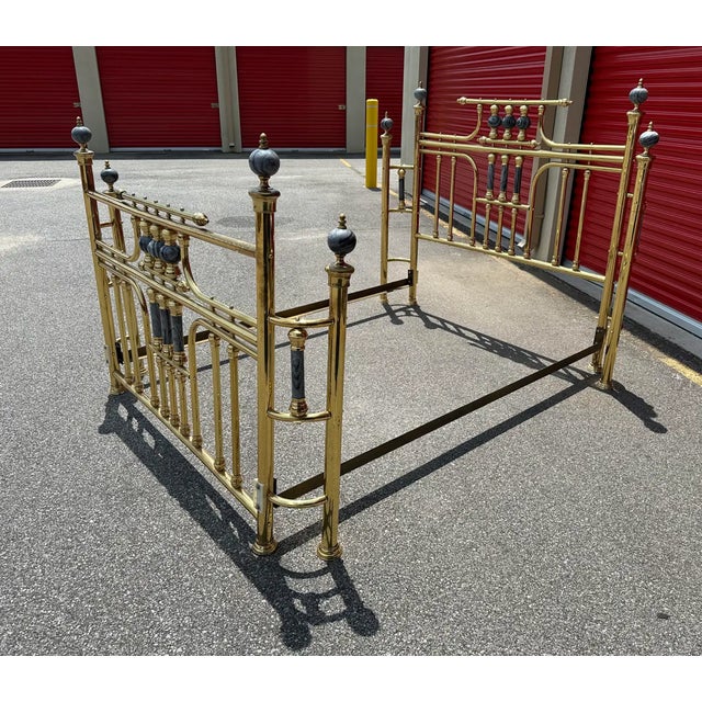 Striking and elegant, this vintage Hollywood Regency-style brass bed frame features a classic spindle design accented with...