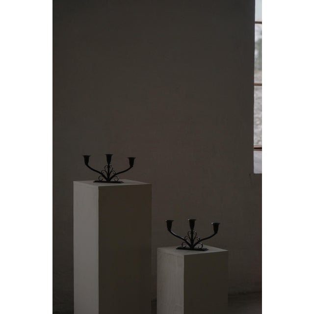 This charming pair of metal candelabra dates from the 1930s and exemplifies refined decorative metalwork from early 20th-...