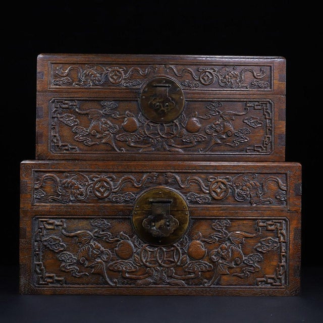 A beautifully crafted set of two Chinese hardwood nesting boxes, likely made of Huali (rosewood). Each box features deep...