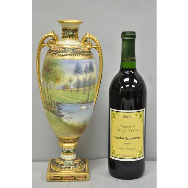 Antique Nippon Hand Painted Twin Handled Gold Gilt Lake & Swan Scene Bolted Urn Vase. Circa Early 20th Century....