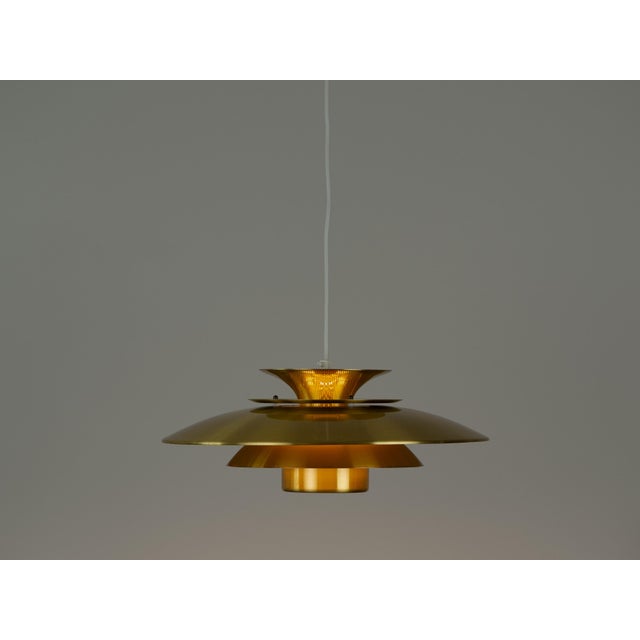 The lamp's form was designed based on the principle of a reflective system that directs light not only downward but also...