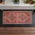 This vintage Oushak rug features a striking medallion design set against a vibrant, sun-faded red field that brings warmth...