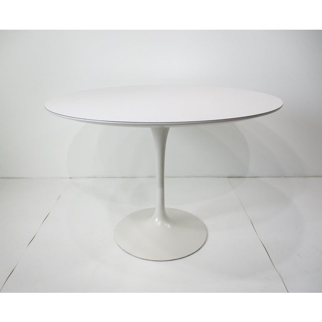 A very nicely sized 42" Dia. cafe or dining table with a round white Laminate top and matching steel tulip base . The...