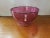This is a Circa 1960 Italian MCM Murano Cranberry Glass Optic Swirl Pattern Footed Centerpiece Bowl with Applied...