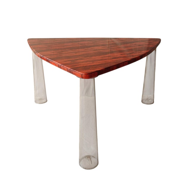 Triangular table with transparent polycarbonate legs, designed by Marcel Wanders, an Italian manufacturer of the company...