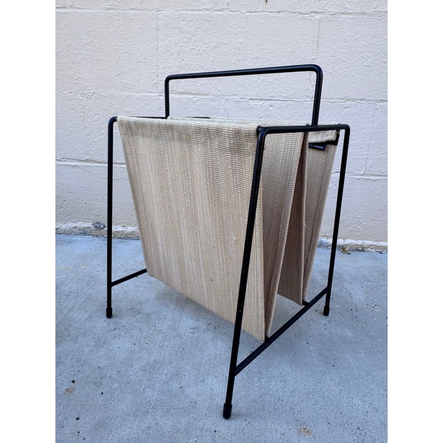 Paul McCobb's Magazine Holder, an authorized reissue by Fritz Hansen in a hard-to-find tan and cream colorway. A slender...