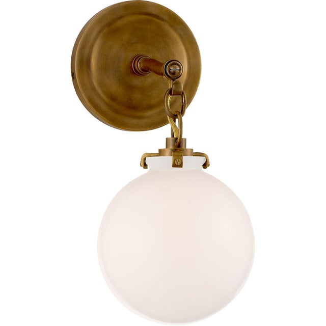 Katie Small Globe Sconce in Hand-Rubbed Antique Brass with White Glass Designer: Thomas O'Brien Height: 12.5" Extension:...