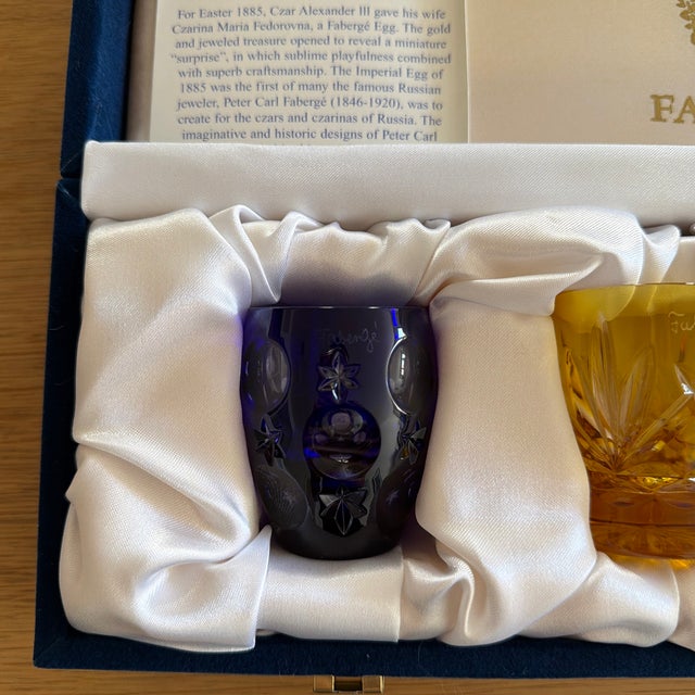 4-piece blue, yellow, red, green crystal Na Zdorovye vodka shot glass set with varying cuts and forms throughout and brand...