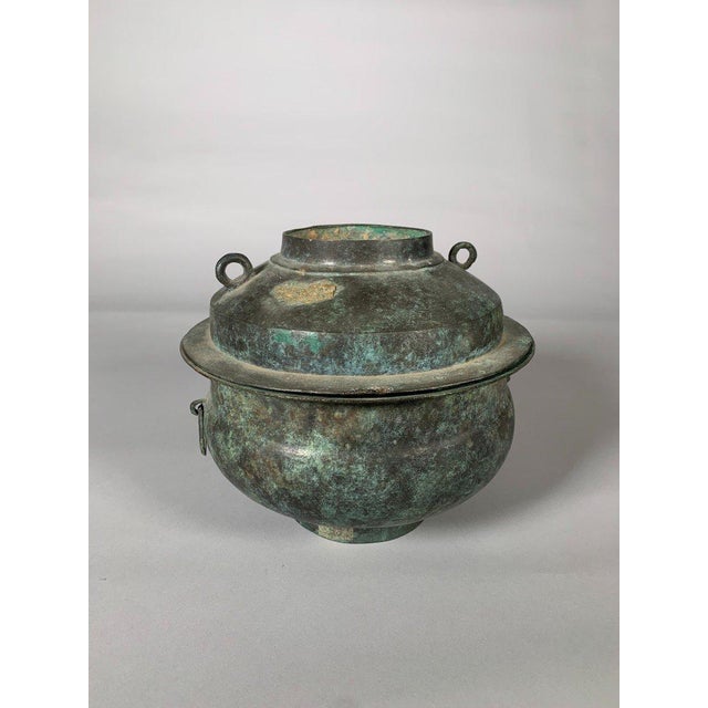 Large bronze offering steamer, Han Dynasty, 206 BC-220 AD. The steamer is composed of three parts: a bowl, a semi-covered...