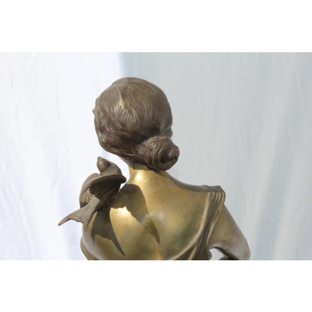 An Antique large size bronze figurine of a girl with birds. Multi-patinas and signed and title by the Artist ( Champagne...