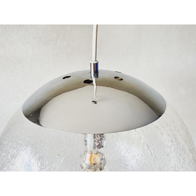 Beautiful mid century lamp. Large glass ball with hundreds of air bubbles in the glass. Gives a nice light effect. Made by...