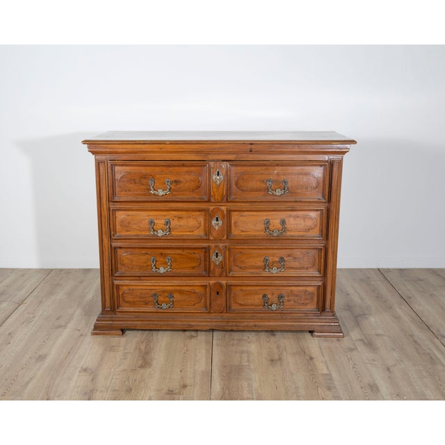 A superb early 18th century chest of drawers from Lombardy, masterfully crafted in rich walnut with architectural presence...