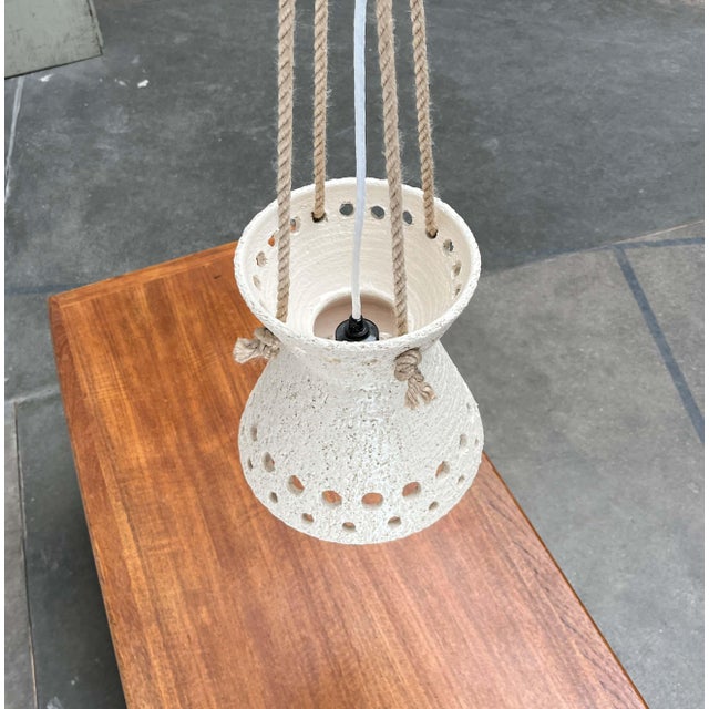 Ceramic pendant lamp from Denmark. An impressive piece, whether switched on or off. The lamp body features the simple and...