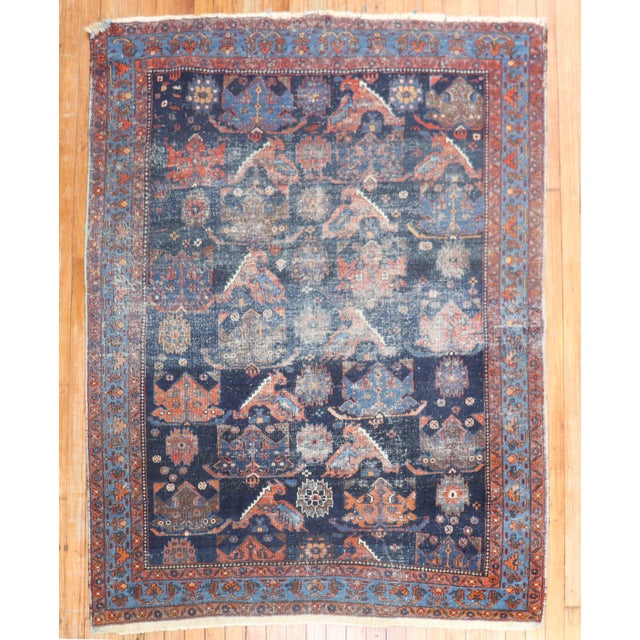 An early 20th-century worn Persian square tribal rug Measure: 4'6'' x 5'7''.