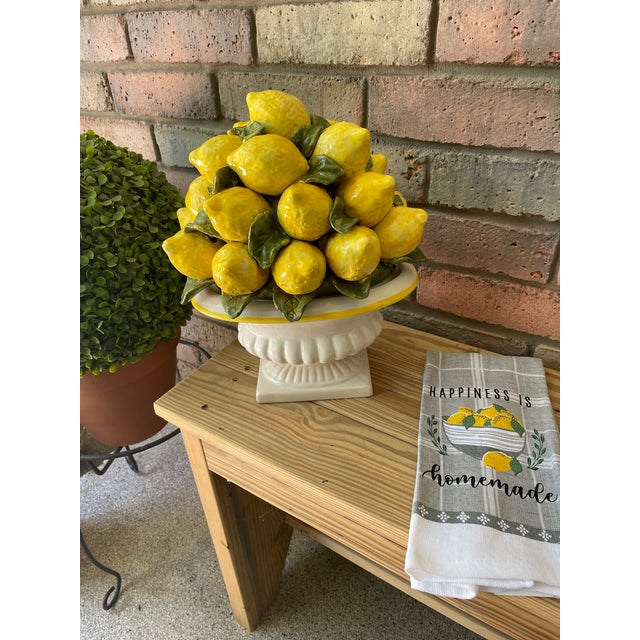 A majestic 13.75" tall ceramic Italian Lemon Topiary sitting in a stunning pedestal bowl. Circa Mid 20th Century. No...