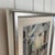 A composed harbor motif rendered in oil on panel, signed and dated 1949. A small boat rests in shallow water before a...