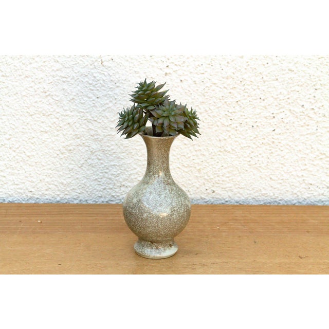 This vessel is a refined example of traditional ceramic work, featuring a classic double-gourd inspired silhouette and a...
