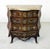 A striking french louis xv style bombe commode, richly decorated with marquetry inlays and ornate gilt metal mounts. Circa...
