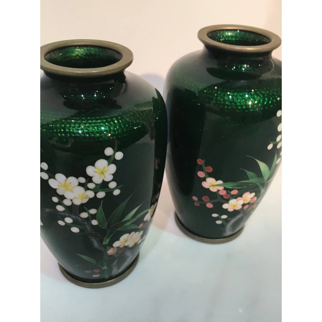 Beautiful pair of cloisonné vases in rich green with delicate flower design. These were in a private collection which is...