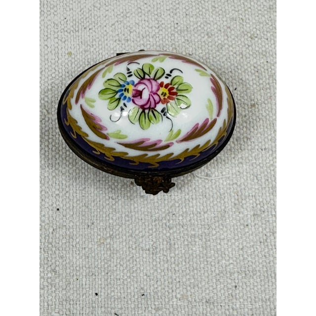 Vintage hand painted Limoges oval box decorated with a floral spray. This is a pre-owned item so please see all pictures...