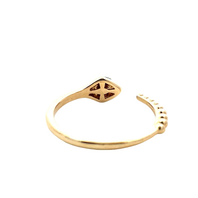 Striking 18K yellow gold rattlesnake-style open ring featuring diamond-set eyes for a subtle yet captivating sparkle. This...