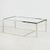 Angular shaped coffee table with chrome legs and glass top from the 1980s. with some surface scratches and wear on the...