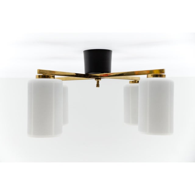 Mid-Century Modern 4-armed brass and glass lamp, 1950s Italy The usual slight signs of wear and a beautiful patina. The...