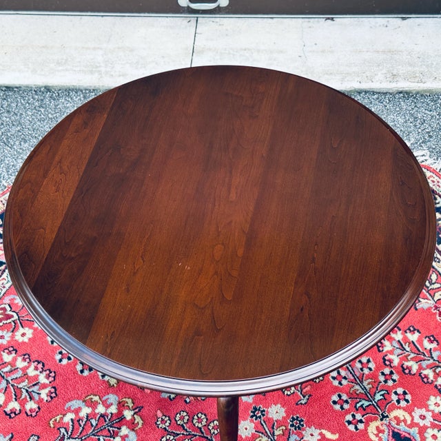 Hard to find vintage Ethan Allen Georgian Court Rotating Tilt Top Table hand crafted from all solid cherry wood in the...