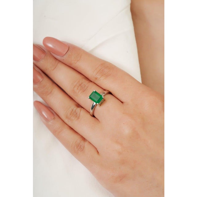Crafted in 925 sterling silver, this natural emerald solitaire ring features a striking octagon-cut emerald (6 x 8 mm,...