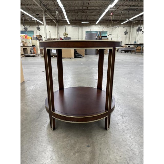 This elegant chairside table boasts a rich cognac finish with champagne striping and light distressing, adding a touch of...