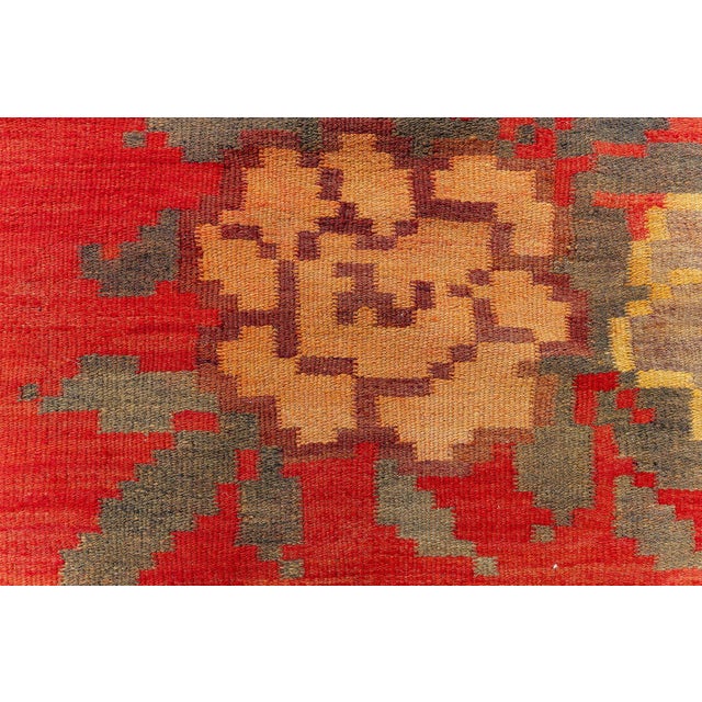 This striking antique Bessarabian rug from the 1920s showcases the region's signature floral artistry rendered in bold,...