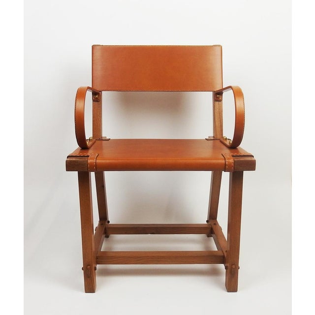 Rare armchair with back, seat and armrests in fawn leather, saddle stitching on a metal and solid oak structure, model...