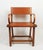 Rare armchair with back, seat and armrests in fawn leather, saddle stitching on a metal and solid oak structure, model...