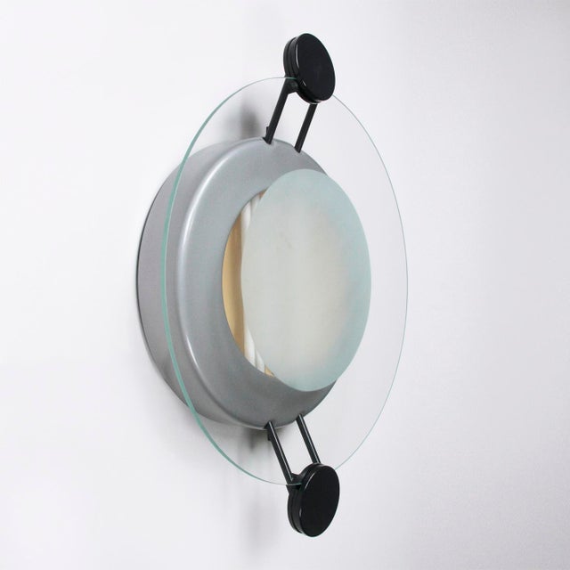 Wall or ceiling lamp designed by Michele De Lucchi and produced by Artemide in the 1980s. Silver-plated metal frame and...