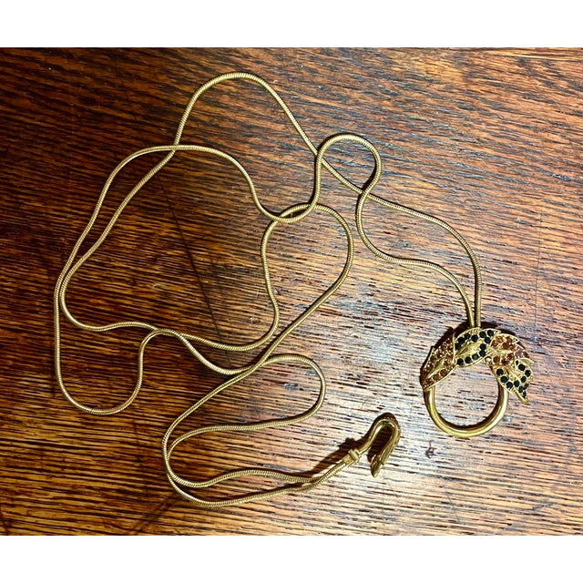 Chic doubled snake chain necklace with round pendant embellished with brown and black crystals. Pendant is 1.5 inches wide...