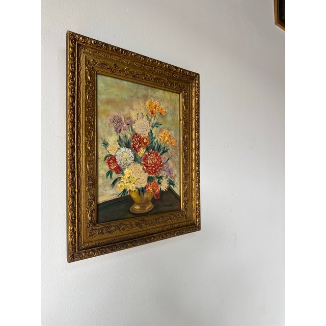 Charming 1970s vintage still life oil painting signed Jeannette, featuring a lush floral arrangement displayed in a...
