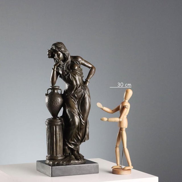 Bronze female figure on a black marble base, sculpture based on a model by Emile Louis Picault. Apocryphal signature on...