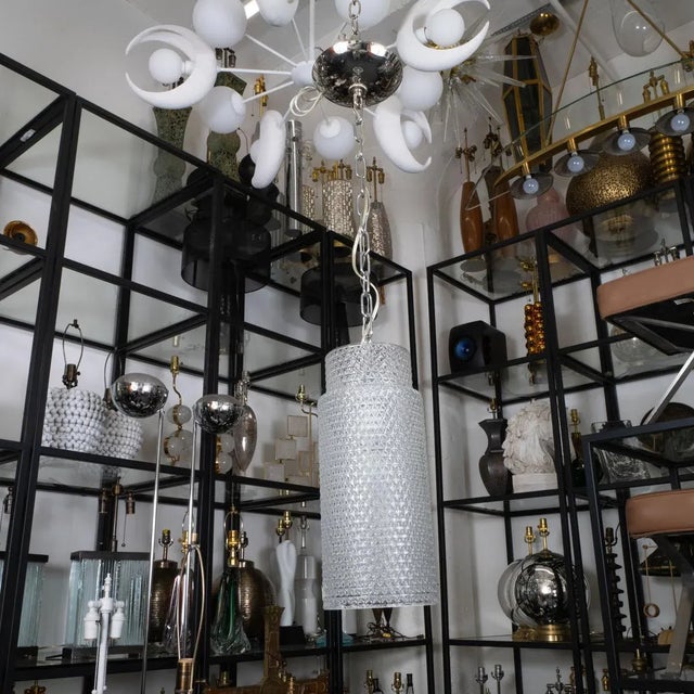 Molded glass cylindrical pendant with nickel hardware.