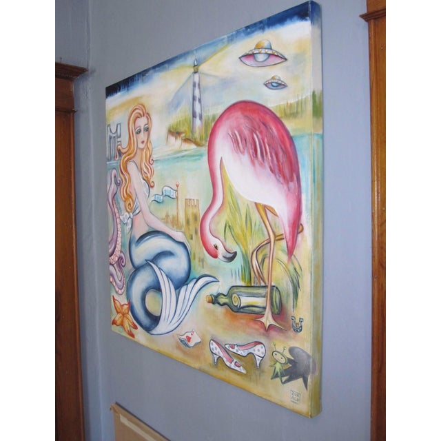 In "Love Lorn," a mermaid with flowing red hair gazes wistfully, surrounded by whimsical elements like a pink flamingo and...