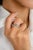 This modern wedding band in 18K white gold showcases five vibrant blue sapphires, each encircled by a halo of sparkling...