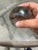This art glass piece is an iridescent hand-blown paperweight crafted by the artist Roger Roland in 1983. It features a...