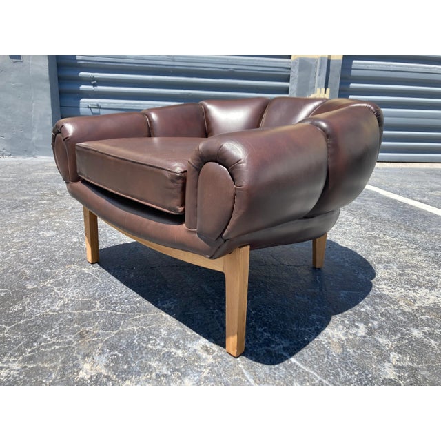 Leather Lounge chair in the style of Illum Wikkelsø. Solid wood base with brown leather upholstery.