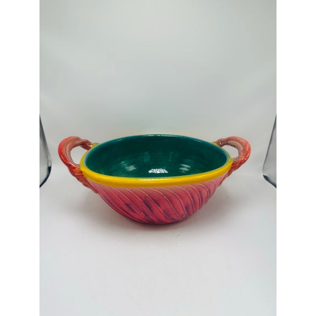 This large handled bowl is a striking and playful piece of ceramic art with a distinctly Mediterranean flair. Description:...
