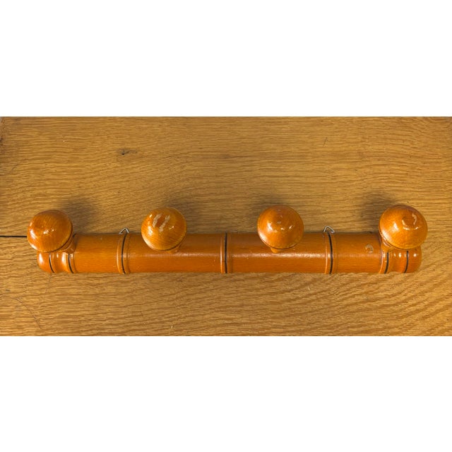 A charming vintage French wooden coat rack crafted in the classic faux bamboo style, a design long favored for its...