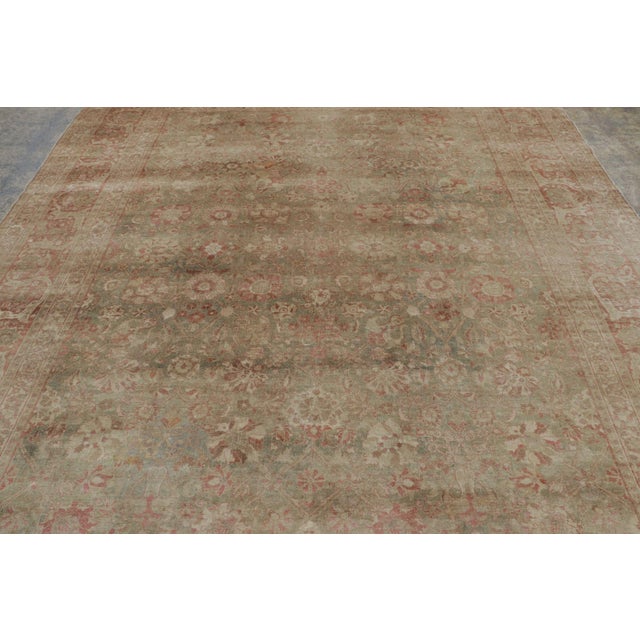 Hand-knotted in wool circa 1950-1960, this 9x11 vintage Persian Tabriz is a sophisticated example of mid-century weaving....